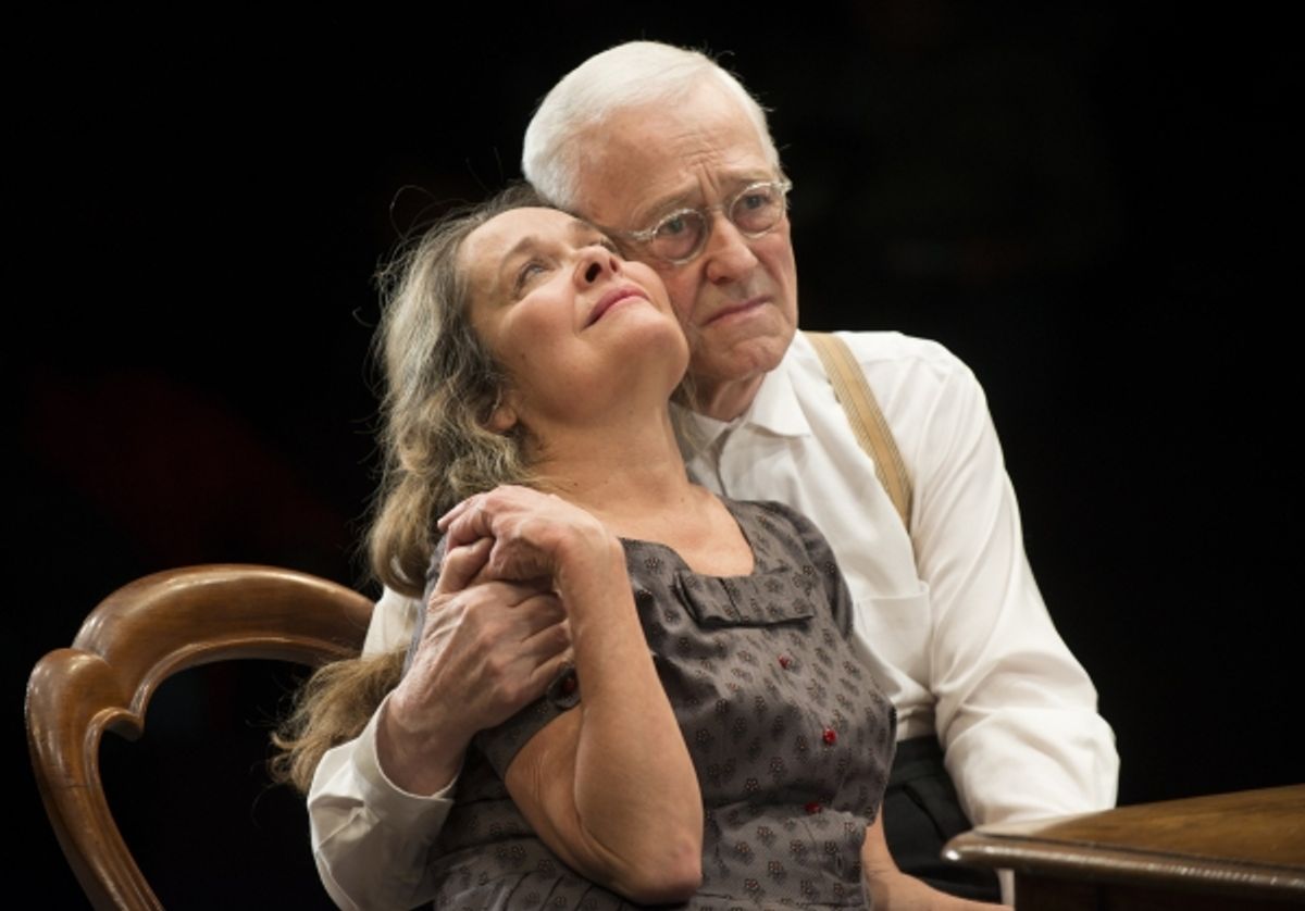 Petey (ensemble member John Mahoney) embraces his wife, Meg (ensemble member Moira Harris) at 