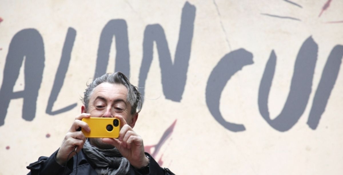 Alan Cumming taking pictures at 