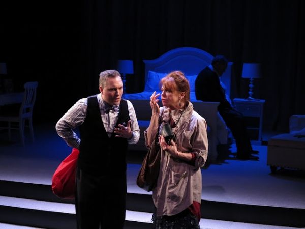 An elderly American vacationing in London (sitting, Jack Davidson) is the subject of  Photo