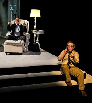  The businessman (Jack Davidson, behind) checks in with his psychologist in L.A. (Eth Photo