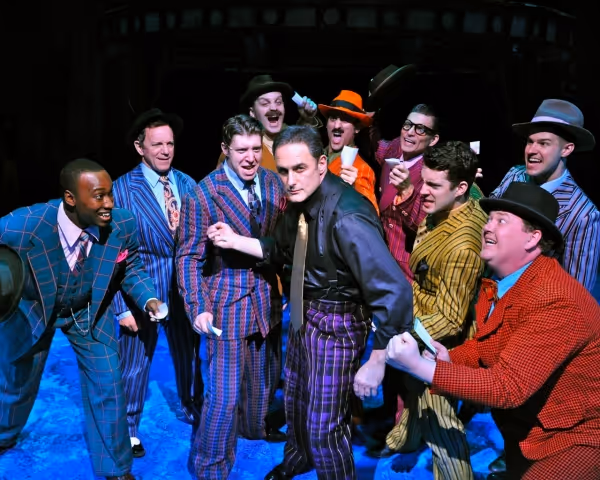 Gary Lynch (center, as Sky Masterson) and ensemble perform 