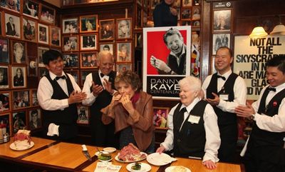 Dena Kaye (center) eats the first Danny Kaye Deli Club. Photo