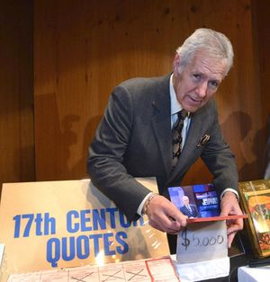 Alex Trebek opens a donated Jeopardy! item Photo