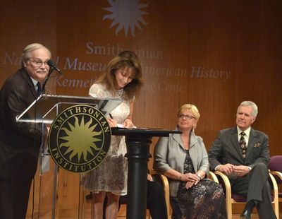 Dwight Bowers looks on as Susan Lucci signs her Deed of Gift Photo