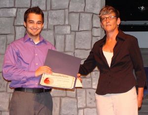 Tanner Uffelman receives award form Ann Davis, executive director Photo