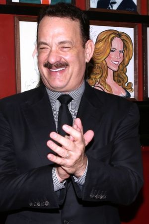 Tom Hanks with wife Rita Wilson caricature behind him @ BroadwayWorld Tom Hanks with wife Rita Wilson caricature behind him Photo