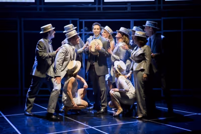 The cast of COMPANY serenades Bobby (Matthew Scott; center) as they sing 'Side By Sid Photo