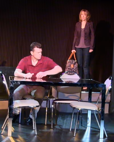 Dan (played by John DeMerell) hears startling news from his wife Diana (played by Dia Photo