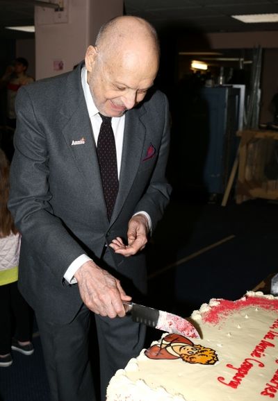 Charles Strouse cuts into the ''Annie'' Logo requested by his grandaughter Photo
