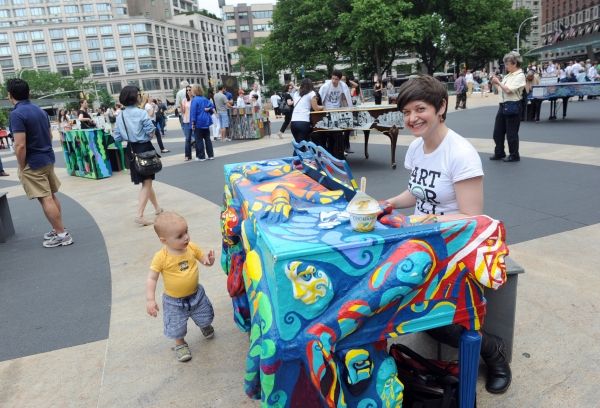Artist Jessica Browne-White plays the piano she designed, one of the 88 Sing for Hope Photo