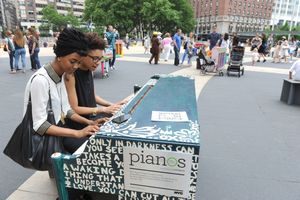 Jay Williams and Lee Bullitt, of New York, play on the piano designed by Arianna Huff Photo