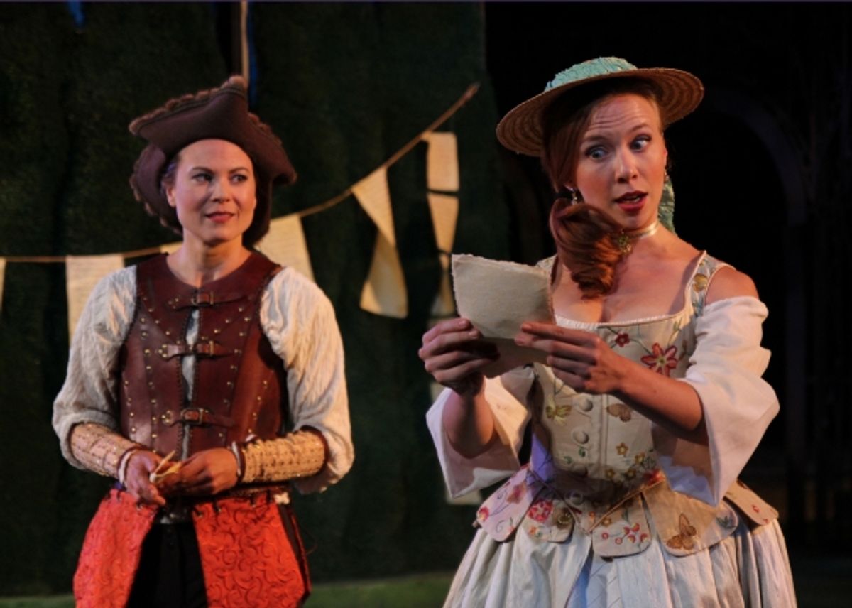 (front) Celia, played by Maria Tholl reads a letter from Orlando to the disguised Rosalind played by Caralyn Kozlowski.  at 