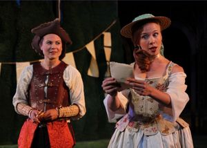 (front) Celia, played by Maria Tholl reads a letter from Orlando to the disguised Ros Photo