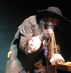 Fagin (DeLarme Landes) contemplates the secret stash of valuable he has saved for his Photo