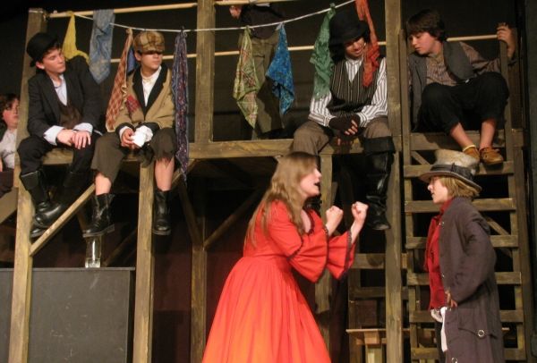 Several young pickpockets (top, left to right,) enjoy the song I'd Do Anything as Nan Photo