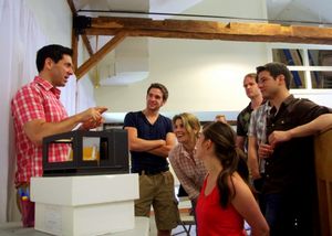 Director Michael Berresse reviews Set Designer Tim Mackabee''s set model with the cas Photo