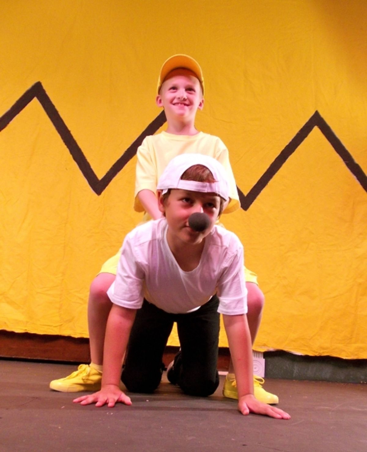 Collin George as Woodstock and Miles Synder as Snoopy at 