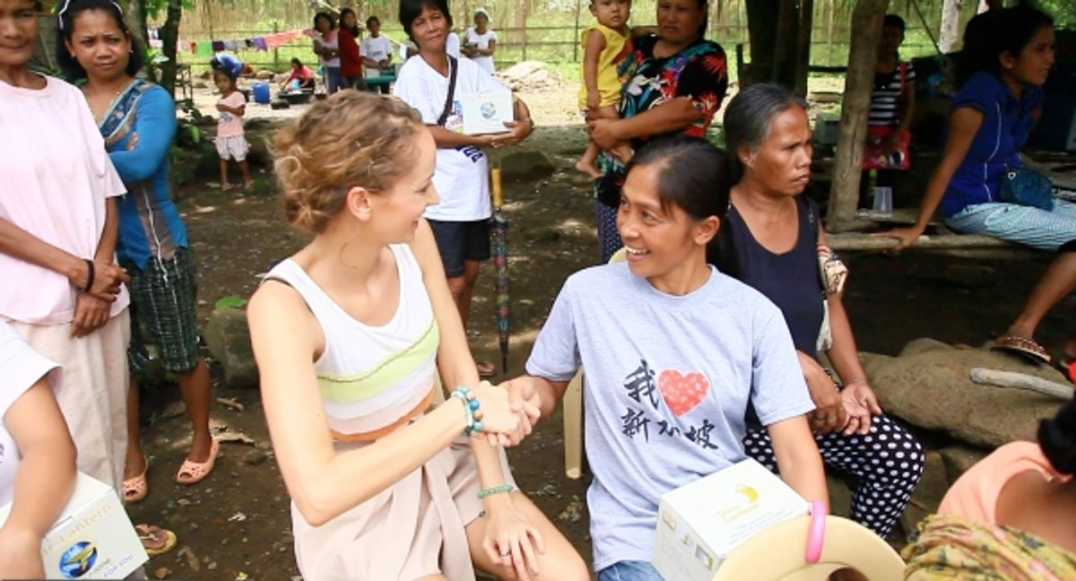 Monika Rofler interacts with one of the lamps'' beneficiaries at 