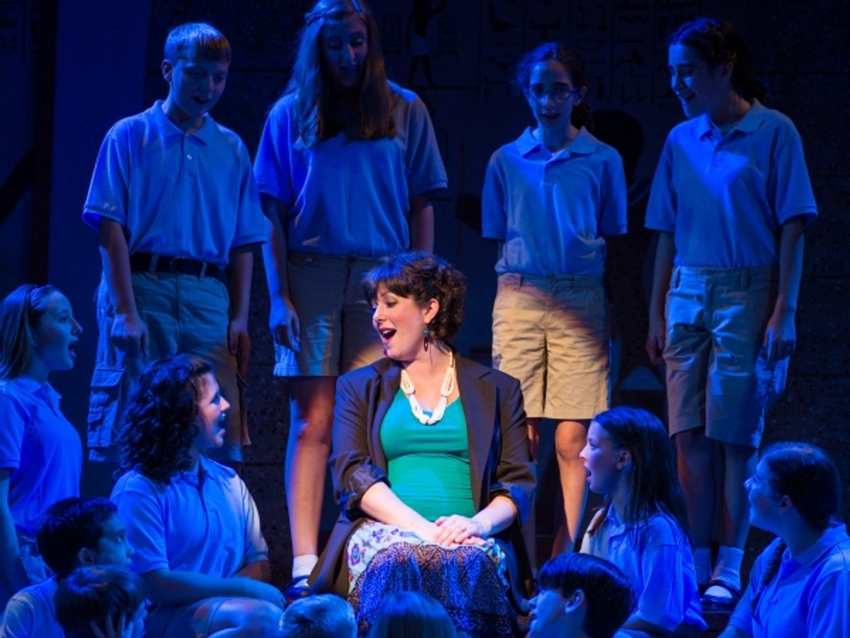 The Narrator, played by Laura Berger, surrounded by members of the children''s chorus. (Top Row: Tommy Cimato, Madison Cichon, Andrea Gameros, Jesse Pike. Bottom Row: India Chudnow, Alex Ohmart, McKenna Spanko, Josh Pike, Delaney Spanko, Nickela Rooney. C at 