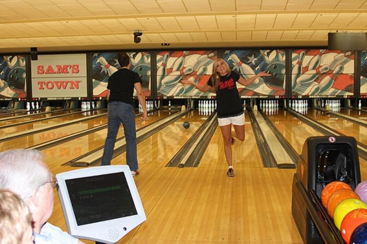 EVIL DEAD stars Ben Stobber (left) and Lynnae Meyers bowling during the tournament at 