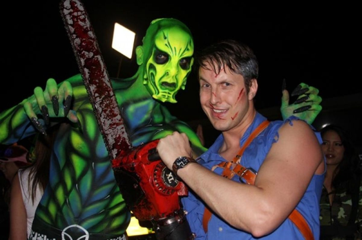 Ash (Ben Stobber) from EVIL DEAD poses with one of the airbrushed models on the pool deck of Binion''s at the Las Vegas Paracon ''Abduction Party'' at 