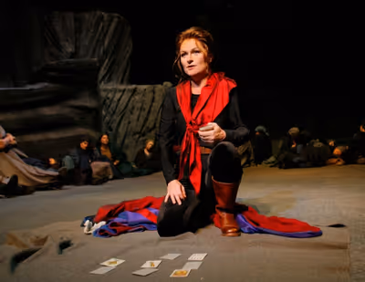 Carmen (Patricia Bardon) predicts her own death when she tells her fortune.  Photo
