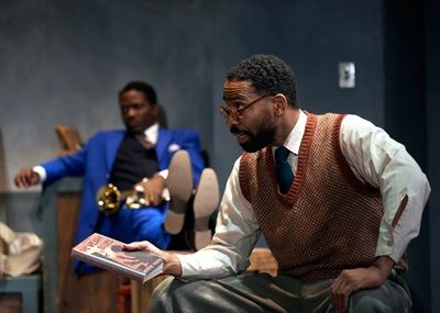 Pianist Toledo (Kevin Carroll*) tells his fellow band members a story Photo