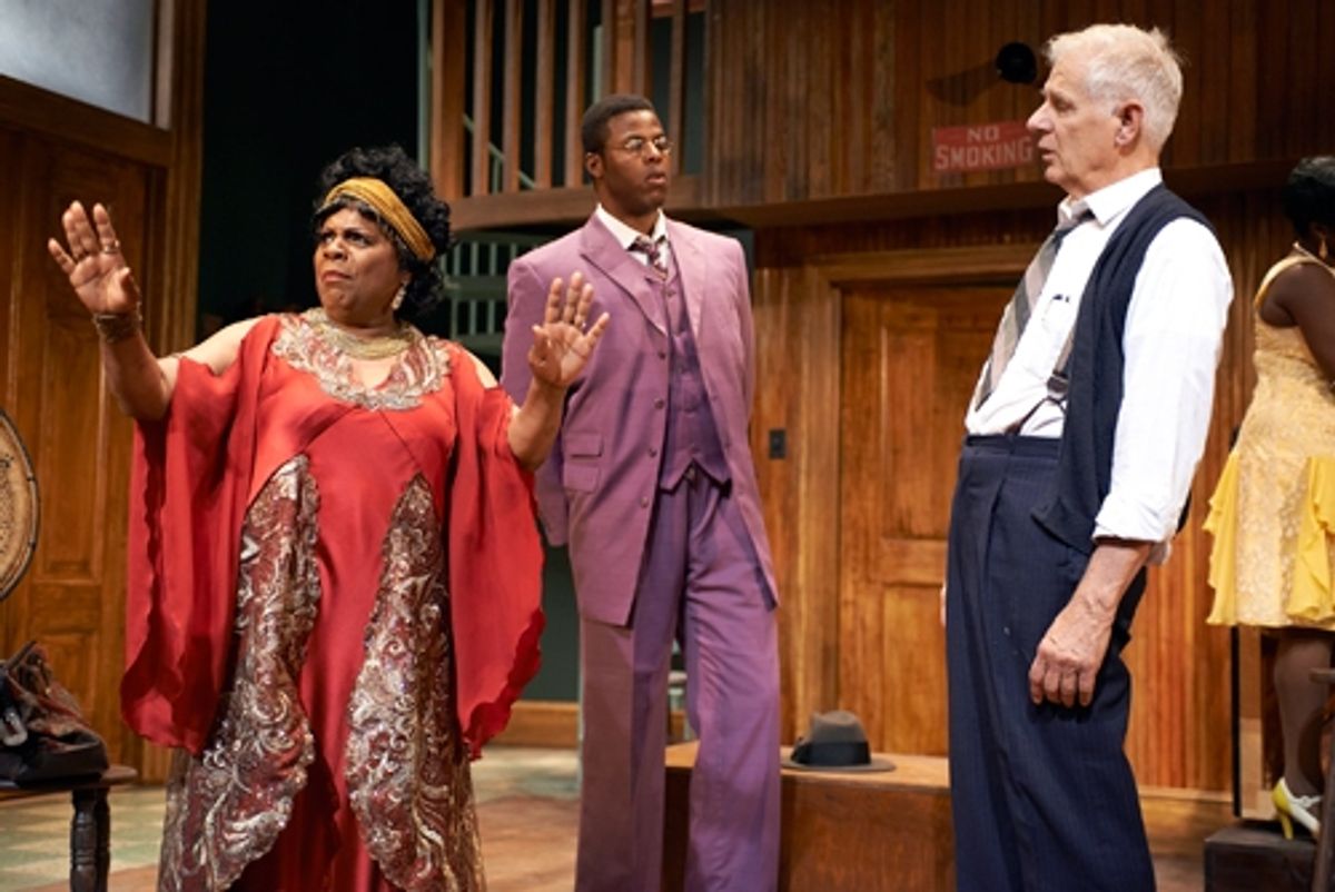 Ma Rainey (Tina Fabrique*) reminds Irvin (Tom Bloom*) that she is the one in charge of this recording session, as her nephew, Sylvester (Winston Duke*) watches at 