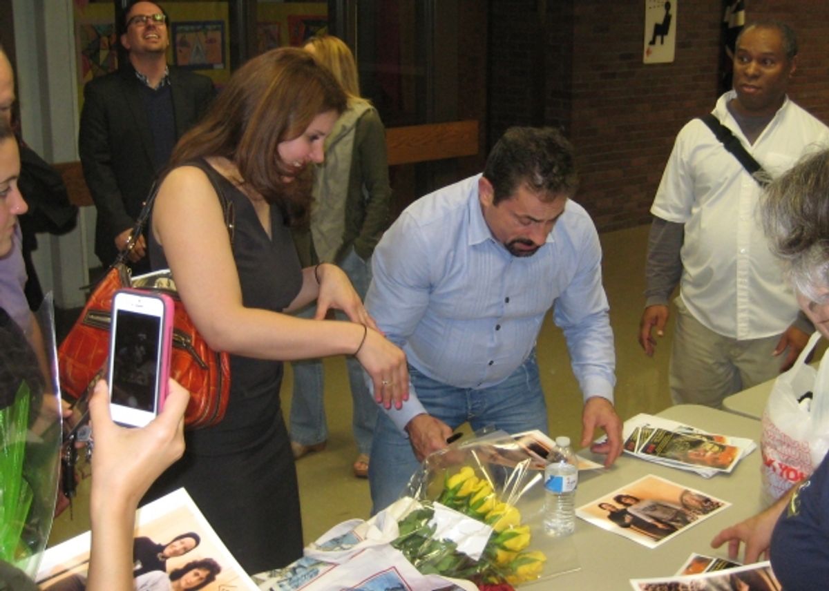 Jerry Torre signs autographs for fans in the audience at 