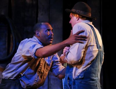 Ken Early as Crooks and Jim Hopkins as Lennie Photo