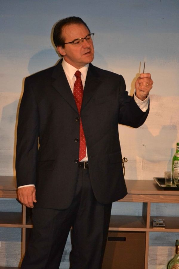 Gerardo (Kevin Daugherty) shows his wife the nail that gave him a flat tire on the wa Photo