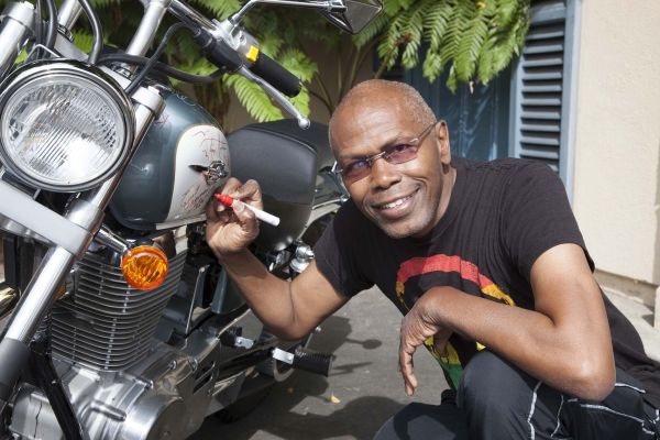 Ernest L. Thomas (What''s Happening) signs bike Photo