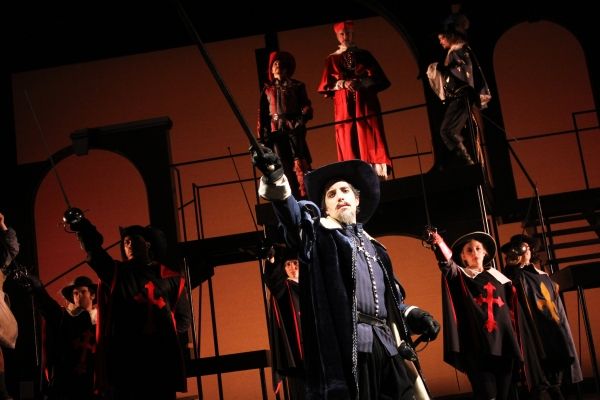Alexander Savronsky as Captain De Treville (center) and (above) Rocco Sisto as… Photo