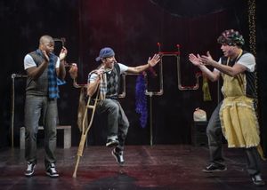 No longer so tiny, the crippled but joyful Lil’Tim (JQ, at center) hip hops along with his parents, Bob Cratchit (Postell Pringle, at left) and Mrs. Cratchit (Jackson Doran). @ BroadwayWorld No longer so tiny, the crippled but joyful Lil’Tim (JQ, at center) h Photo