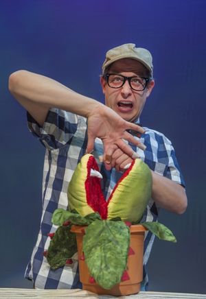 Seymour (Adam Cotugno) feeds Audrey II Photo