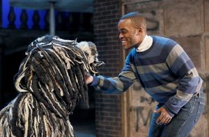 Russell (Travis Turner) and Zoopy the dog (puppeteer Sam Deutsch) enjoy a thrilling s Photo