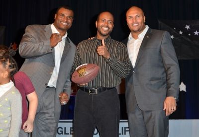 Former Giants players Jessie Armstead and Antonio Pierce surprise East Orange''s Anti Photo