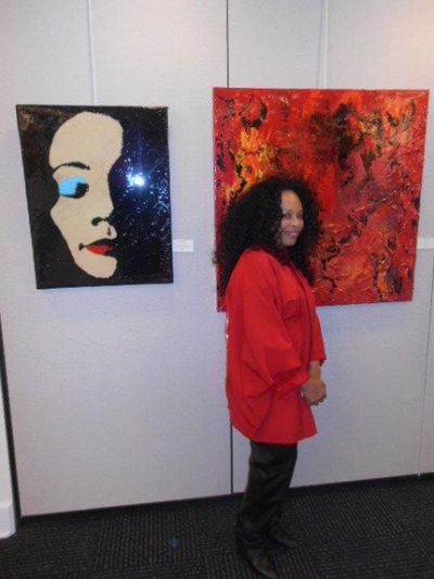 Tina Andrews in front of her work Photo