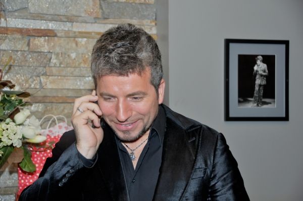 Remigio Pereira on the phone with a fan Photo