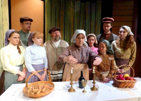 Tevye''s family begins Sabbath with two special visitors.  (from left: Carly Linehan, Photo