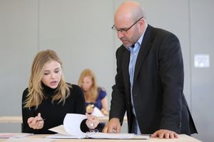 Chloe Grace Moretz and Scott Z. Burns (center) Photo