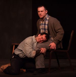 Katurian (Tom Mazzarella, kneeling) seeks comfort after his interrogation from his brother Michal (Neil Battinelli, seated) @ BroadwayWorld Katurian (Tom Mazzarella, kneeling) seeks comfort after his interrogation from his br Photo