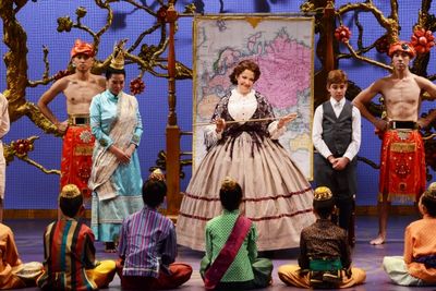 Michele Ragusa (as British schoolteacher Anna Leonowens), center, teaches her student Photo
