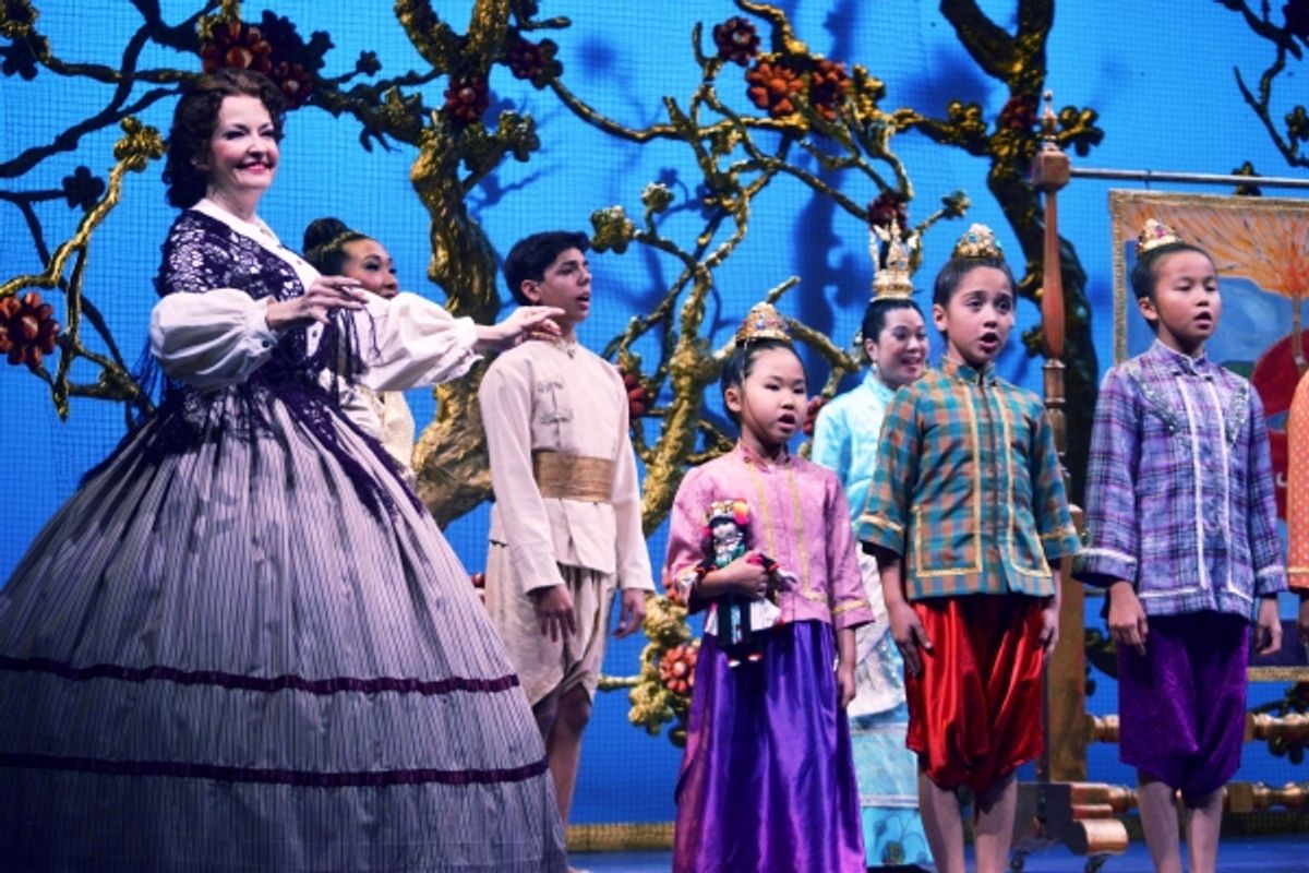 Michele Ragusa (as British schoolteacher Anna Leonowens), left, leads her pupils in song at 