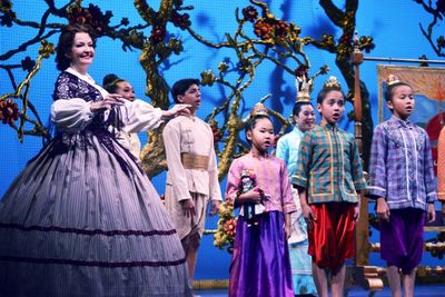 Michele Ragusa (as British schoolteacher Anna Leonowens), left, leads her pupils in s Photo