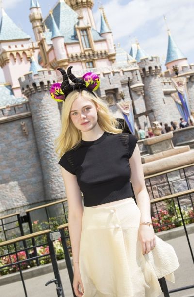Elle Fanning poses at Sleeping Beauty Castle at Disneyland Photo