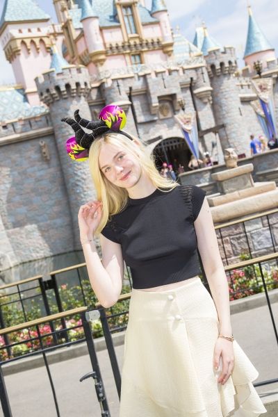 Elle Fanning poses at Sleeping Beauty Castle at Disneyland Photo