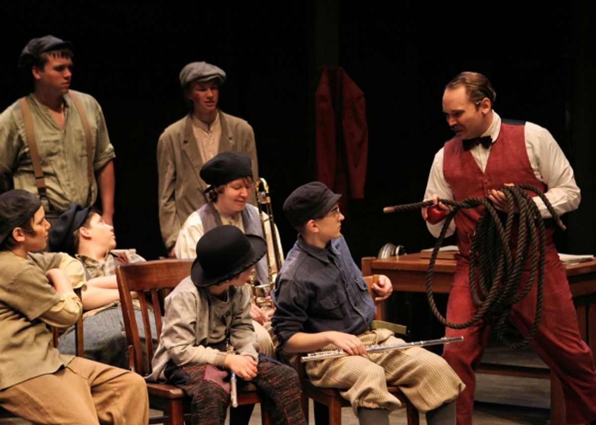 A.W. Warnock (Randy Schmeling) points out to the boys (l to r, front row: Jonah Harrison, Joshua Harrison, Izzy Karr; second row: Jack Alexander, Shelby Ernst; standing: Rory Mitchell, Chalres Couture) that ''all boys are working boys'' at 