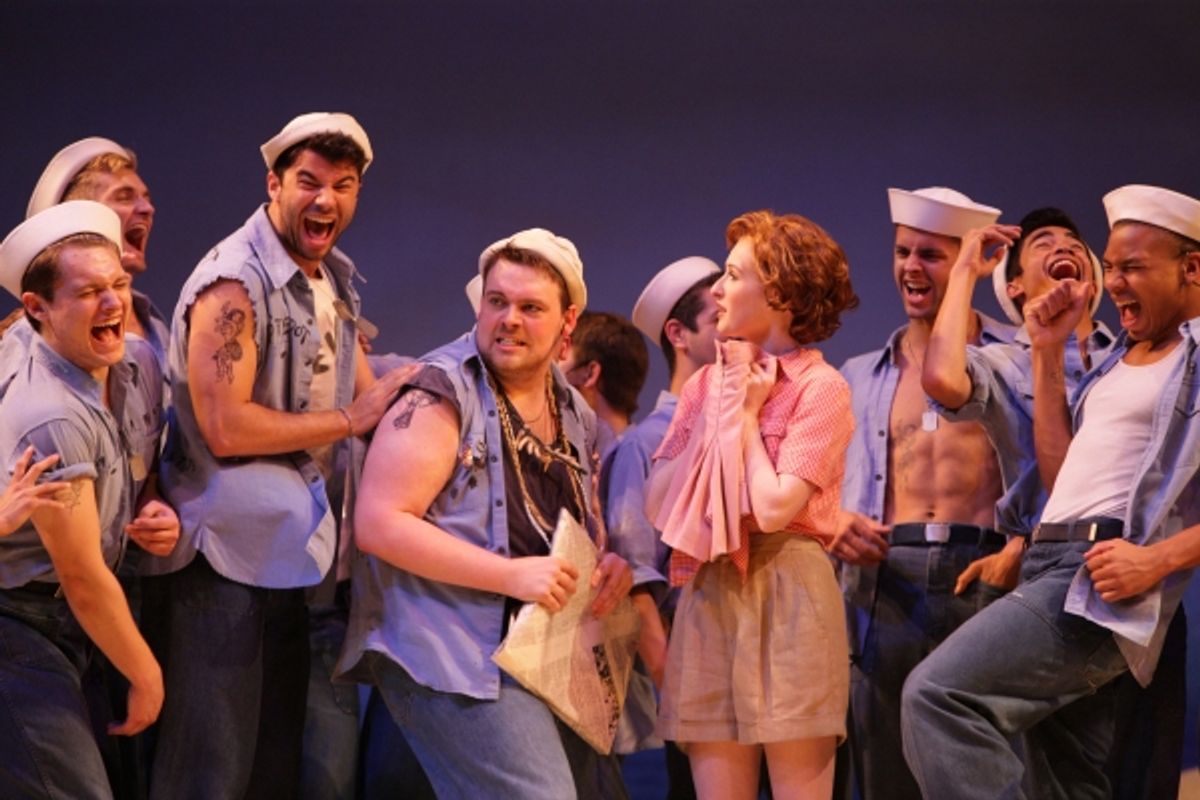 Nellie (Erin Mackey) gets her laundry from Billis (J. Bailey Burcham) and the island Seabees at 