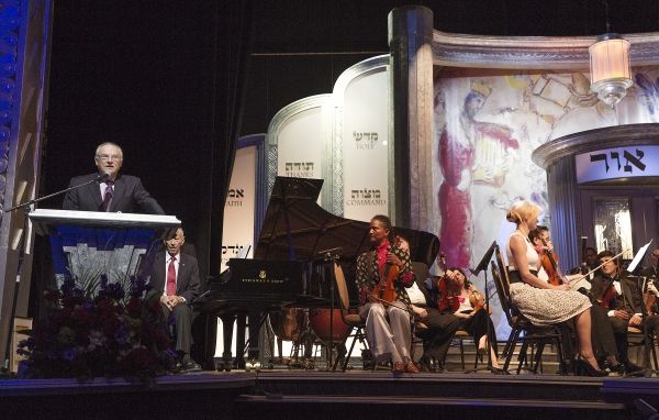 Event Emcee Bill Smitrovich at podium at An International Evening of  Music and Remem Photo